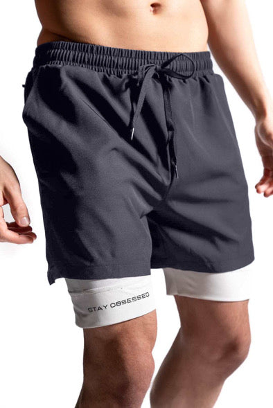 Men's black drawstring shorts with elastic waistband and light gray undershorts