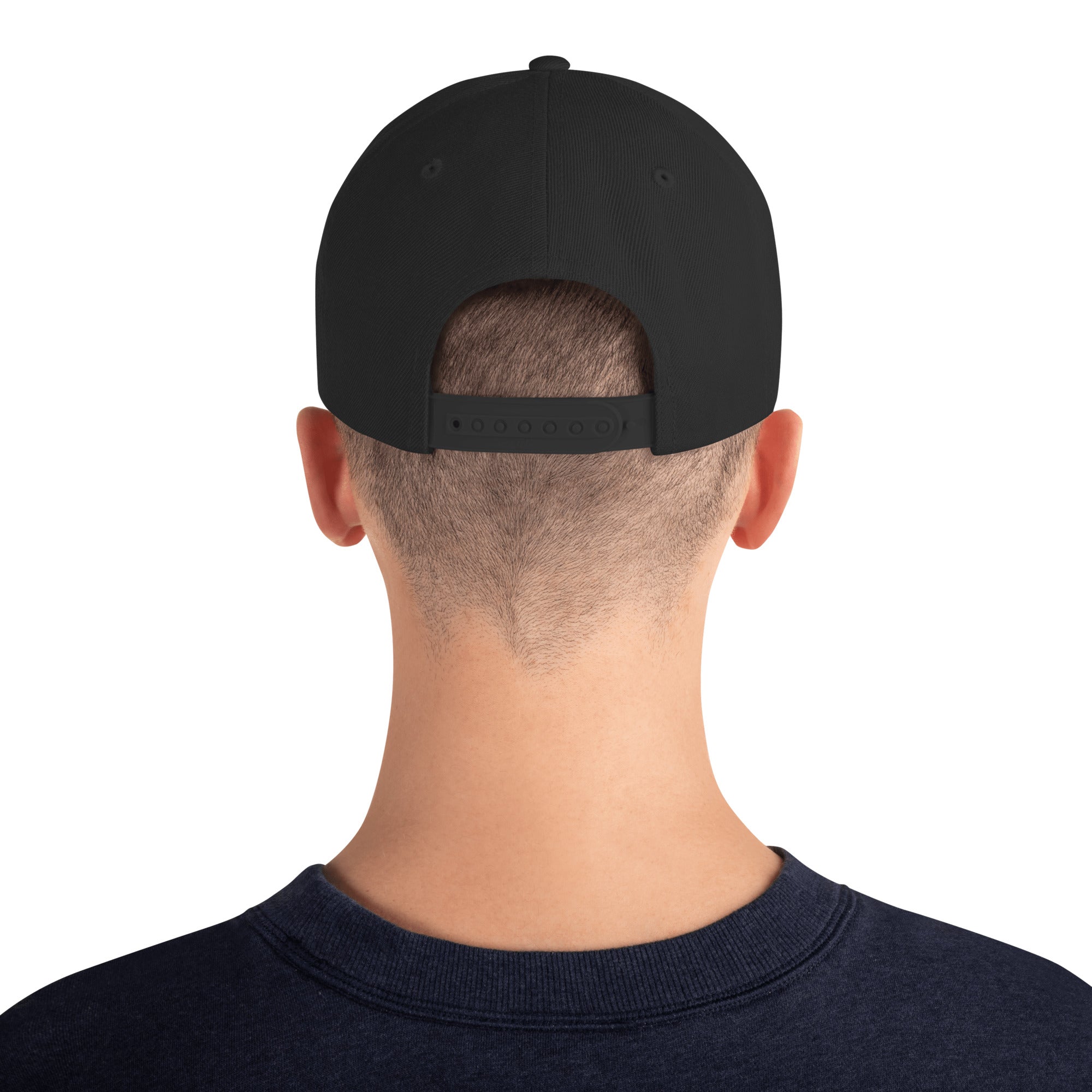 Black snapback hat back with adjustable strap and visible stitching near buckle