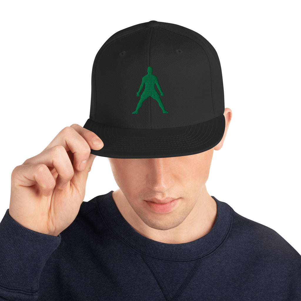 Black snapback hat with green 3D puff embroidered figure graphic at center front