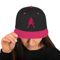 Black snapback hat with pink brim, worn by a person, dancer embroidery