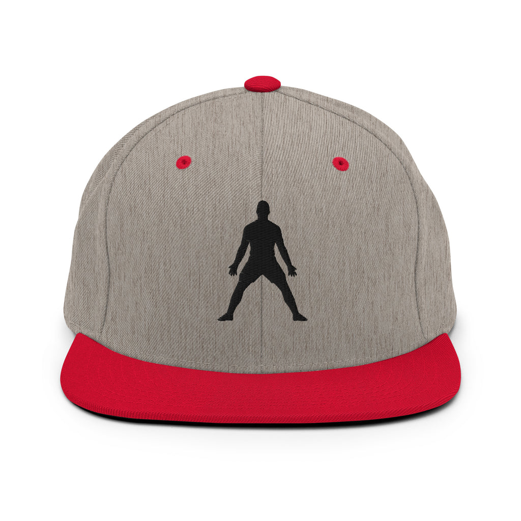 Gray snapback hat with red underbrim and black embroidered figure on front.