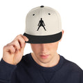 Cream snapback hat with black underbrim and black 3D puff silhouette emblem